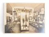 an old photo of a man standing in a glass case