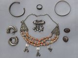 a necklace, bracelets, and other jewelry on a table