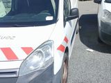 a white van parked in a parking lot next to a white van
