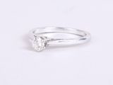 a white gold engagement ring with a single diamond