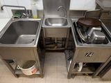 two sinks in the kitchen with pots and pans on them