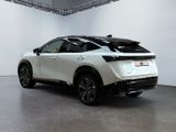 the rear end of a white suv parked in a showroom