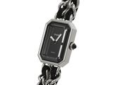 an image of a close up of a wrist watch with a chain around it