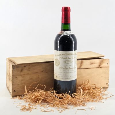 a bottle of wine sitting next to a wooden box