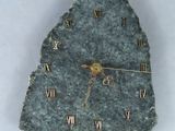 une horloge en pierre sur laquelle figurent des chiffres romains