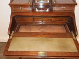 a small desk with a clock on top of it