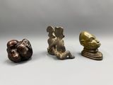 three bronze figurines of a man and a woman