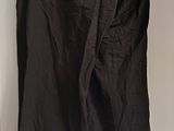 a black pants hanging on a hanger in a room