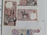 several different bank notes are on a piece of paper on a table