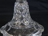 a clear glass bowl with a gold rim on a black background