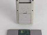 an old nintendo game console sitting on top of a table next to a hard drive