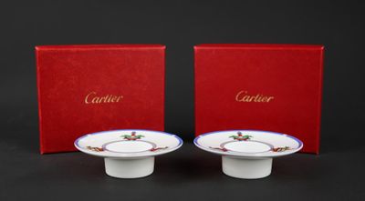 pair of red and white plates with gold trim and a red box