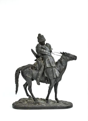 statue of a man riding a horse with a bird on its back