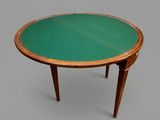 a small table with a green top on a gray surface