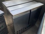 two microwaves that are sitting in the corner of a room