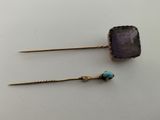 a pair of earrings with a purple stone and a turquoise bead