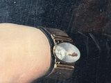 a painting of a woman ' s arm with a watch on it