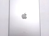 an apple ipad sitting on top of a white table next to a white wall