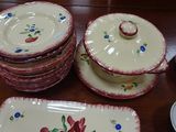 many plates and bowls sitting on a table together