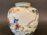 a white vase with a picture of a man riding a horse on it