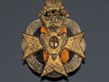 a close up of a badge with a crown on top of it