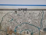 an old map of a city on a wall in a room