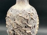 a white vase that is sitting on a table