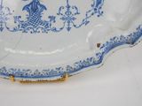 a blue and white plate with a bird design on it