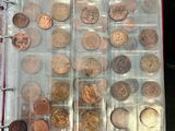 a lot of coins that are in a binder