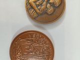 two coins sitting next to each other on top of a white surface
