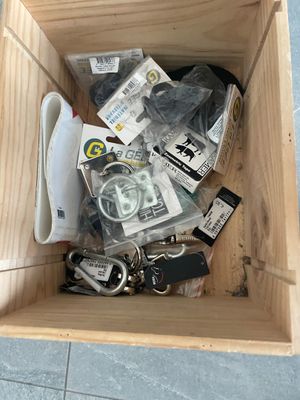 a wooden box filled with assorted items on the floor