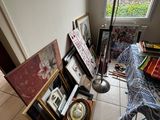 an image of a living room with a lot of art on the floor