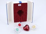 a box with a heart and two flowers inside of it
