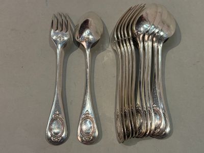 a lot of silver spoons and forks on the table