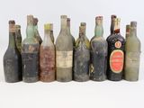 several old bottles of alcohol are lined up in a row