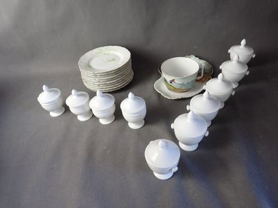 a lot of white dishes and cups on the table