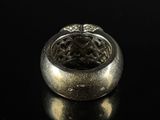 an image of a silver ring on a black surface