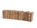the old books are lined up in rows on a white surface