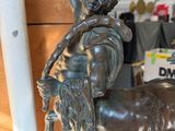 bronze statue of a boy on a horse with a man on the back