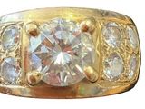 an image of a gold ring with a large diamond surrounded by smaller diamonds