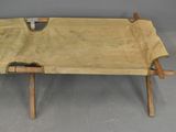 an image of a wooden bench with a tan cover on it