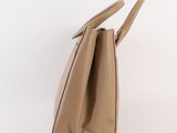 the large tan leather tote bag is made from a soft leather material and has two handles