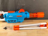 a close up of a toy gun and a tripod on a table