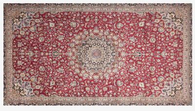 a red rug with a medallion design on it