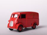 a red toy truck that is sitting on a white surface