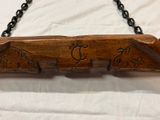 a wooden sign hanging on a chain on a white sheet