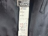 a close up of a label on a black jacket on a hanger