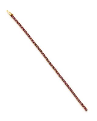un gros plan d'un bracelet violet et doré sur fond blanc