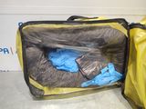 a yellow suitcase with a blue bag inside of it