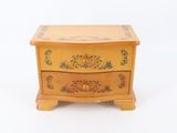 a small wooden box with a floral design on it